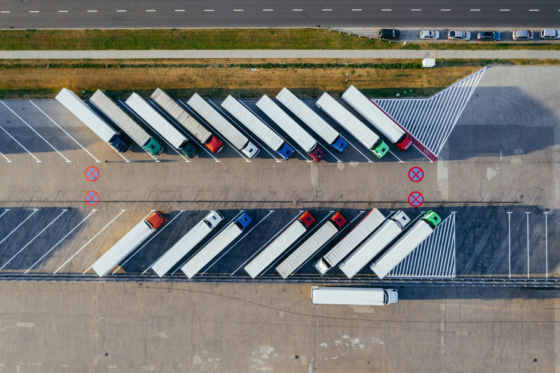 Rows of lorries parked at a truck stop, seen from above